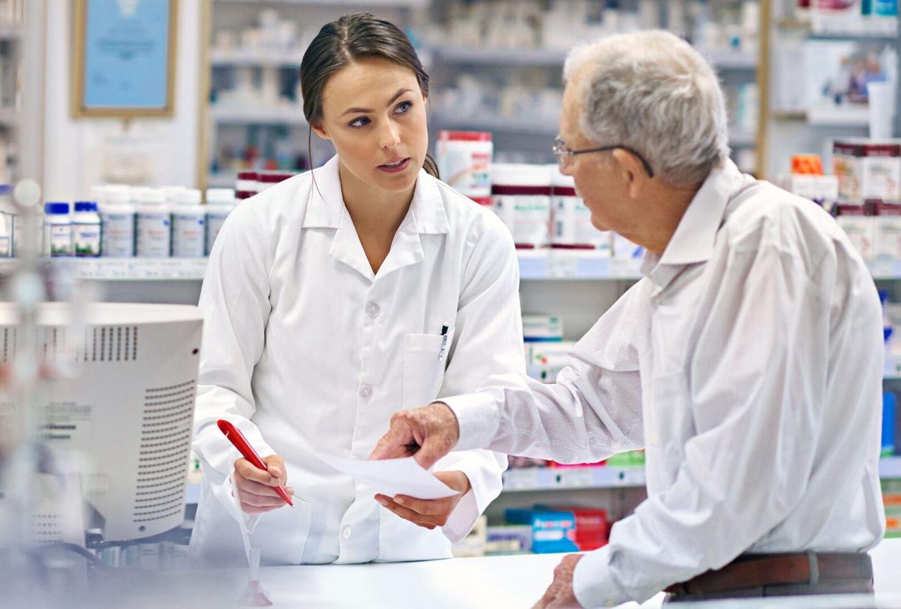 Pharmacist assisting a customer at the pharmacy counter